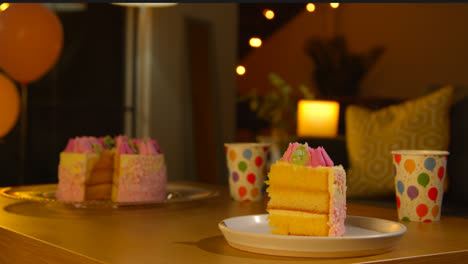 Slice-Of-Party-Celebration-Cake-For-Birthday-Decorated-With-Icing-On-Table-At-Home-6